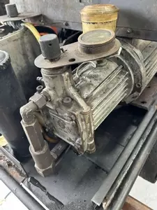 Original worn pump on a Kew 1502V hot pressure washer before full pump recondition and restoration.